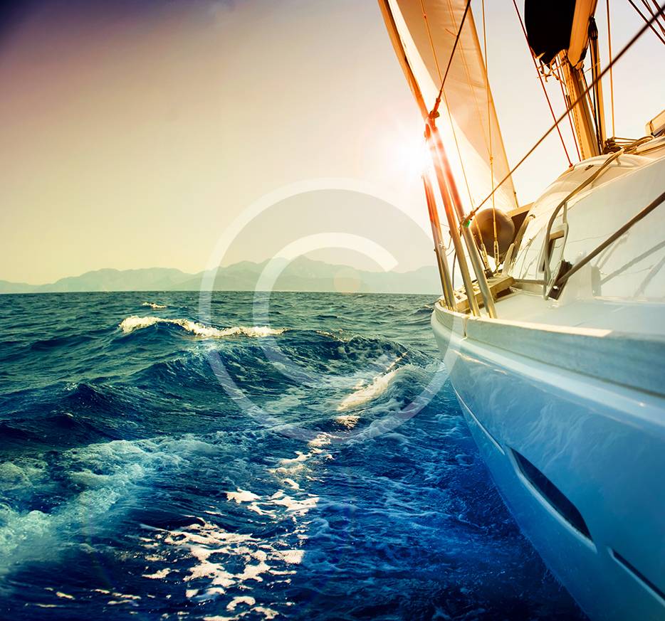 bigstock-Yacht-Sailing-against-sunset-S-23359352.jpg
